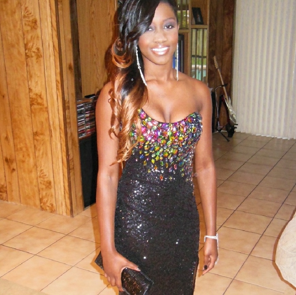 Black sequins dress with high leg slit.